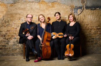 String quartet players of Ensemble 360 with their instruments